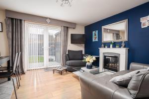 a living room with a couch and a fireplace at 2 Bedroom Home with Garden and Free Parking in Litherland
