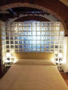 a bedroom with a bed and a glass wall at Real Taste of Tuscany in Florence