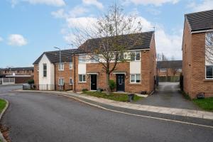 an empty street with brick houses and a tree at 2 Bedroom Home with Garden and Free Parking in Litherland
