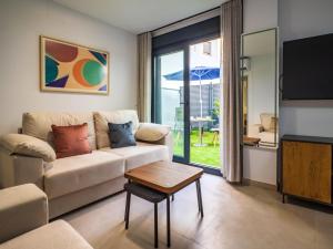a living room with a couch and a table at Huelin Edificio Apartamentos in Málaga
