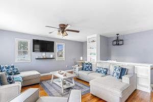 a living room with couches and a ceiling fan at Waterfront 4BR w Dock & Kids Rec Room in Berlin