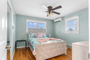 a bedroom with a bed and a ceiling fan at Waterfront 4BR w Dock & Kids Rec Room in Berlin