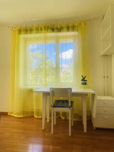a table and a chair in a room with a window at Cosy Studio in Tartu Center in Tartu