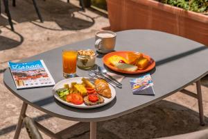 a table with a plate of food and drinks on it at Casa do Jasmim by Shiadu in Lisbon