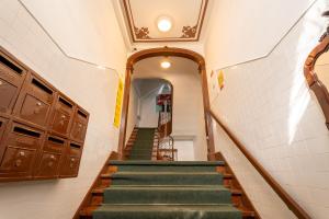 a stairway with green stairs in a building at Casa do Jasmim by Shiadu in Lisbon