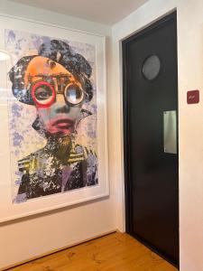 a painting on a wall next to a door at Frank86 in Băile Tuşnad