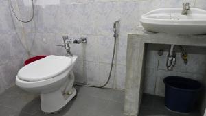a bathroom with a toilet and a sink at Green Mellow Court 2 in Dipolog