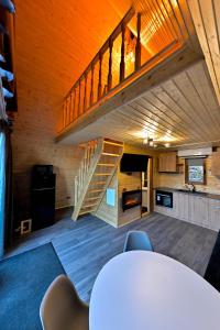 a room with a table and a staircase in a house at A-frame Frumusica in Păltiniş