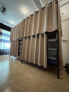 a row of curtains on a wall in a room at Happy Bunk Hostel Weligama in Weligama +6 photos