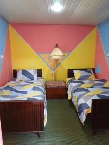 Llit o llits en una habitació de Rossi Rest House