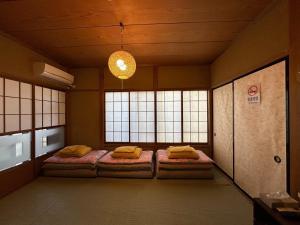 two beds in a room with two windows at Numazu - House - Vacation STAY 59955v in Numazu