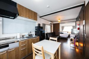 a kitchen and living room with a table and a dining room at Vacation Rental NISHIDA - Vacation STAY 61687v in Kagoshima