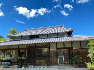 a house with a tin roof at Shima no Gochisō, Kominka Cafe to Yado Awa - Vacation STAY 66758v in Awaji