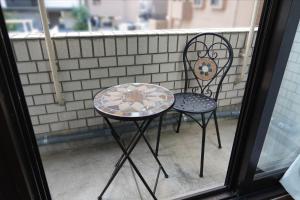 a table and two chairs sitting on a porch at THE TORII - Vacation STAY 21195v in Kumamoto