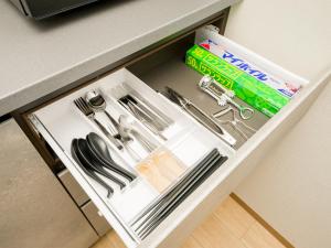 a drawer filled with silver utensils in a cabinet at Rakuten STAY Nikko Hoden No pets allowed Capacity of 6 persons in Nikko