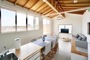 a kitchen and living room with a table and chairs at and SEA The Terrace - Vacation STAY 72600v in Kamogawa