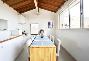 a kitchen with a long table and chairs at and SEA The Terrace - Vacation STAY 72600v in Kamogawa