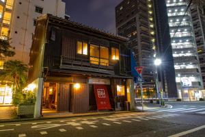 a building on the side of a city street at night at Machiya Villa Seian - Vacation STAY 11749 in Fukuoka