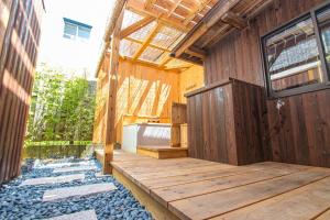 a wooden house with a wooden floor and a wooden deck at Machiya Villa Seian - Vacation STAY 11749 in Fukuoka +4 photos