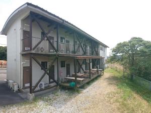 a large building with a balcony on the side of it at ＬＯＤＧＥ ｎ"ｔｒｉｂｅ - Vacation STAY 79116v in Nichinan