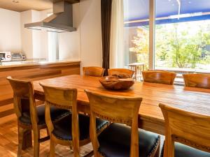a dining room with a wooden table and chairs at Kawaguchiko Villa FJ Resort - Vacation STAY 63288v in Fujikawaguchiko +37 photos