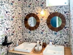 a bathroom with two sinks and floral wallpaper at Kawaguchiko Villa FJ Resort - Vacation STAY 63288v in Fujikawaguchiko