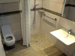 a bathroom with a toilet and a sink at Ferienwohnung Am Hochrhein in Murg