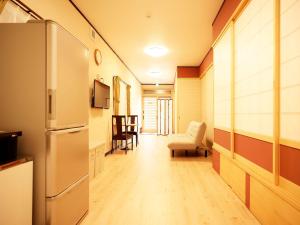 a hallway of a room with a refrigerator and a chair at Mcity in Maejima - Vacation STAY 54881v in Naha