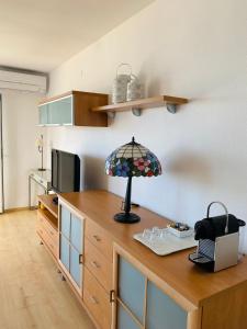 a kitchen with a table with a lamp on it at Apartament VoraMar in Sant Carles de la Ràpita +21 photos