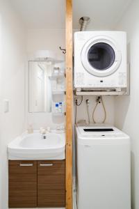 a bathroom with a sink and a washing machine at Vent du Vent 402 - Vacation STAY 83691v in Urasoe +68 photos
