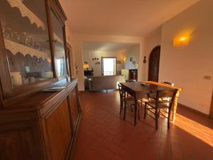 a living room with a table and a dining room at Villa Rosanna - views and woods near Florence in San Donato in Collina +28 photos
