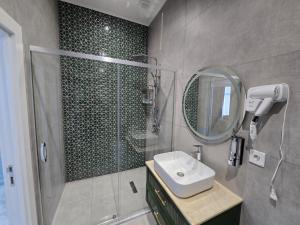 a bathroom with a shower and a sink and a mirror at Sands of Time Apart Hotel in Baku +127 photos