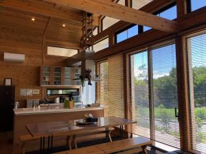 a kitchen with wooden walls and windows and a table at Polar Haus NishiKaruisawa1 - Vacation STAY 87981v in Oiwake