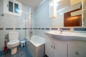 a bathroom with a sink and a toilet and a sink at Apartaments Lamoga - Boabi in Torredembarra +112 photos