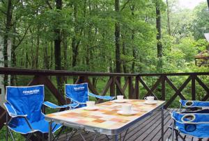 a table and chairs on a deck with a chessboard at HARUNA LODGE - Vacation STAY 12175 in Nasu