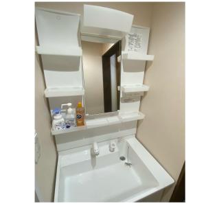 a bathroom with a sink with a mirror at niseko kamahale village - Vacation STAY 91397v in Ōmagari