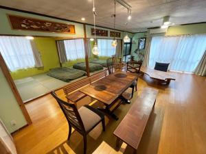 a living room with a table and chairs and a couch at Komorebi - Vacation STAY 91398v in Miyako Island