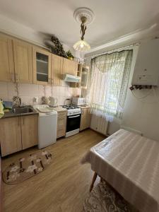 a kitchen with a sink and a stove at Затишна 2 кімнатна квартира Трускавець in Truskavets