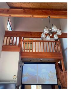 a wooden ceiling with a chandelier and a large window at HARUNA SKY - Vacation STAY 78634v in Nasu