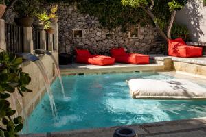 a swimming pool with a water fountain at Palazzo Mandurino luxury relais in Zollino