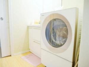 a white washing machine in a white laundry room at Polar House NishiKaruisawa2 - Vacation STAY 00265v in Oiwake