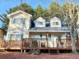 a house with a large porch and a deck at Polar House ShinKaruisawa1 - Vacation STAY 00271v in Karuizawa