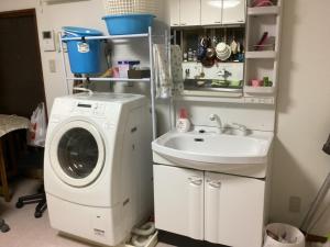 a laundry room with a sink and a washing machine at Osaka and house - Vacation STAY 16309 in Osaka
