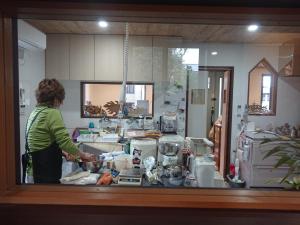 a woman standing in a kitchen preparing food at MAHALO - Vacation STAY 05296v in Saikai +4 photos