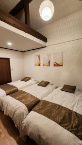 a group of four beds in a room at Hida Takayamasan no machi House - Vacation STAY 98088v in Takayama