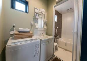 a bathroom with a washing machine and a sink at HAKATA TERRACE -akari- - Vacation STAY 12420 in Fukuoka +20 photos