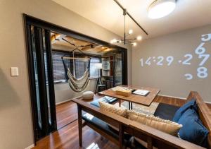 a living room with a couch and a table at HAKATA TERRACE -akari- - Vacation STAY 12420 in Fukuoka