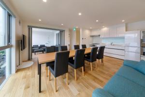 a dining room and kitchen with a table and chairs at SEASIDE TERRACE SUN - Vacation STAY 12430 in Numazu +6 photos