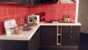 a kitchen counter with a sink and a microwave at Il Conventino Appartamento in Osimo