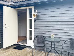 a patio with a table and two chairs on a house at 6 person holiday home in Gränna in Gränna